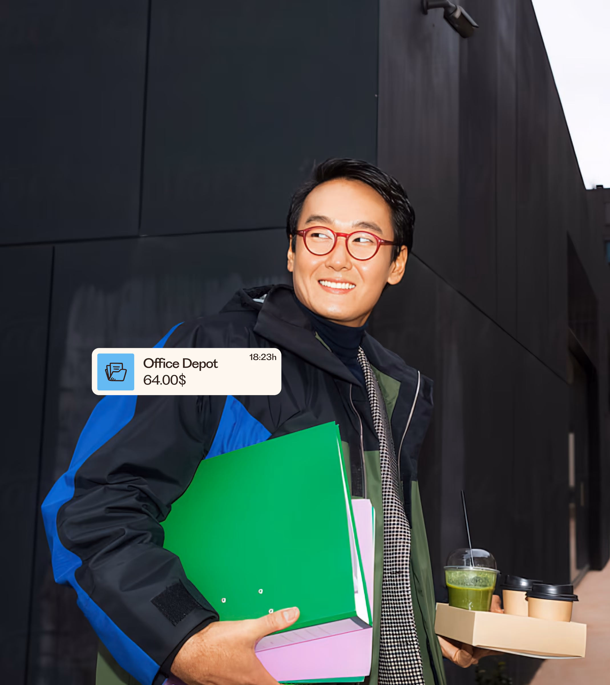 Man carrying folders and coffee with a Remono notification showing an Office Depot payment