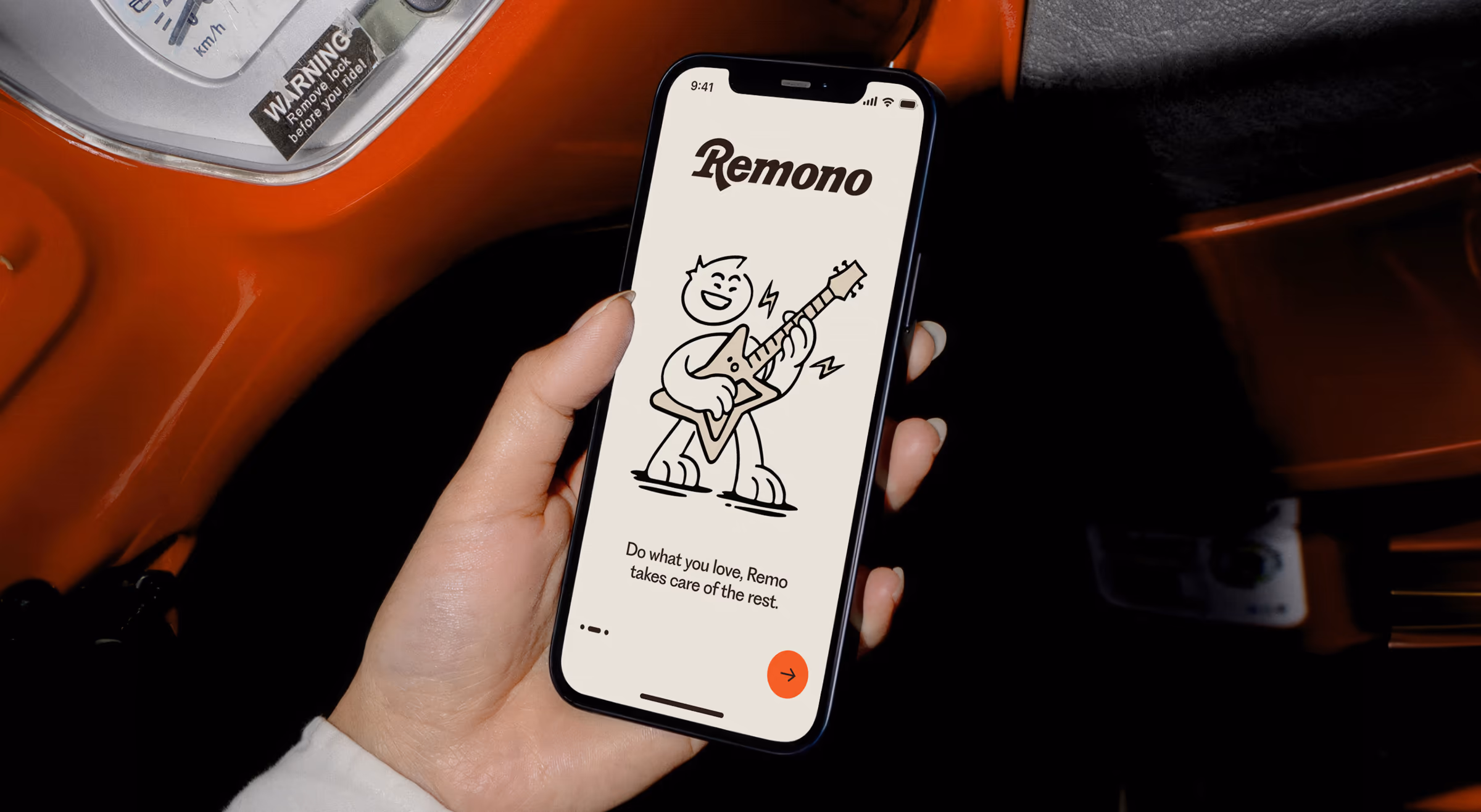Hand holding a phone with a Remono onboarding screen, the mascot playing guitar