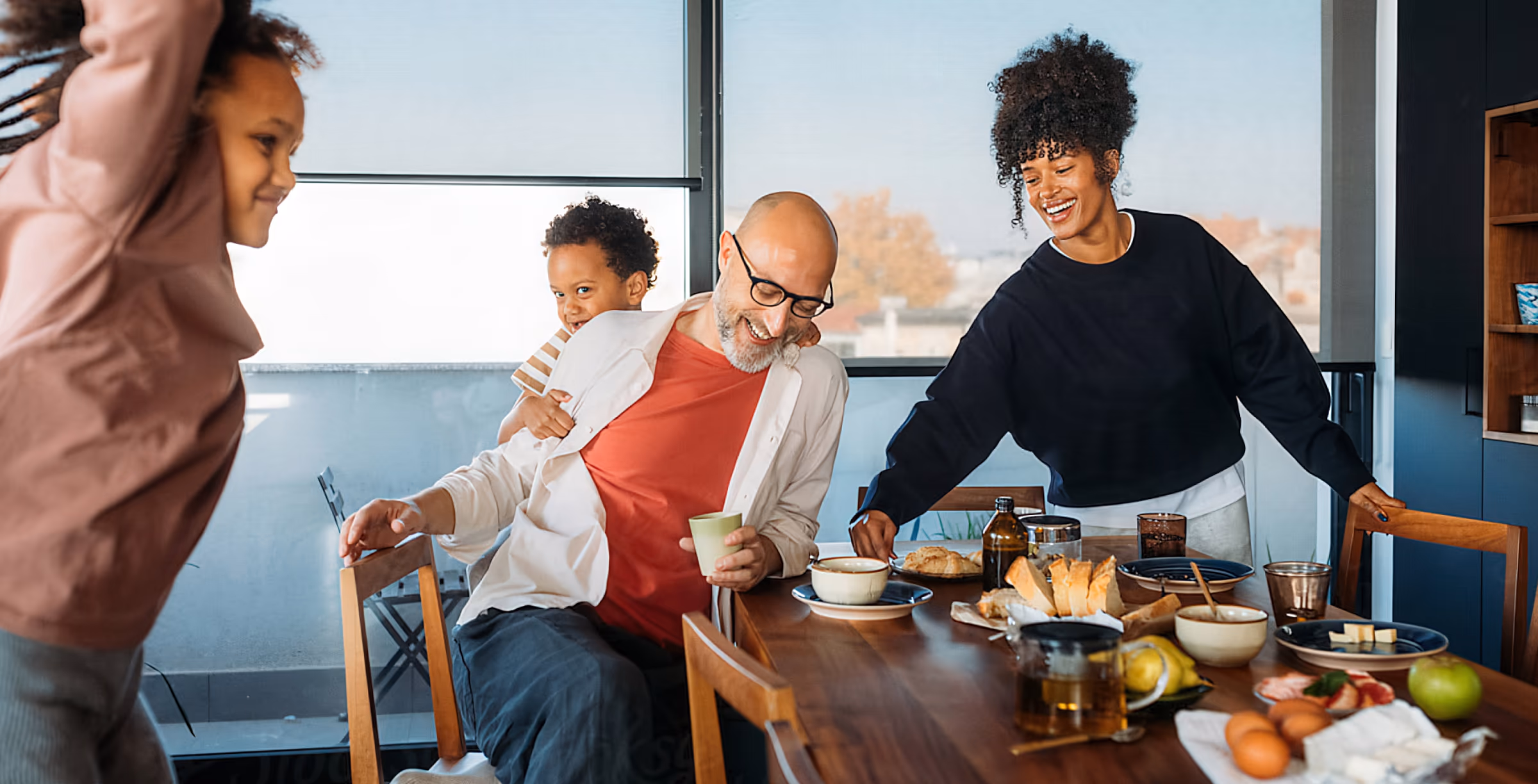 Family having breakfast together at a kitchen table, Remono brand photography