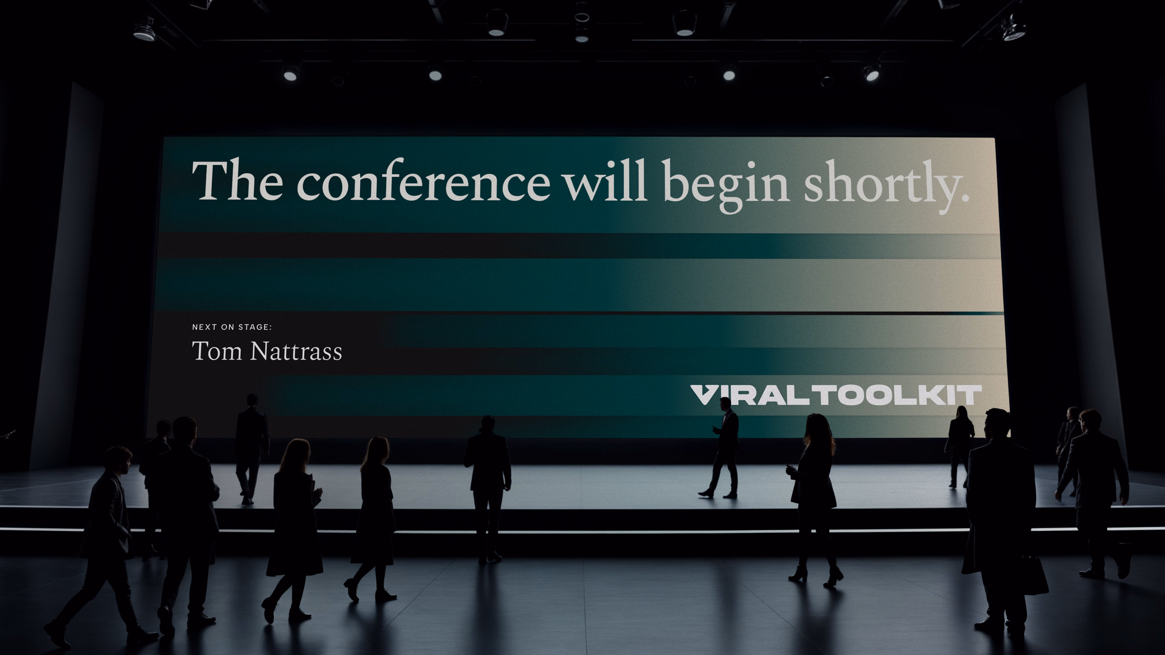 Conference screen reading The conference will begin shortly, next on stage Tom Nattrass